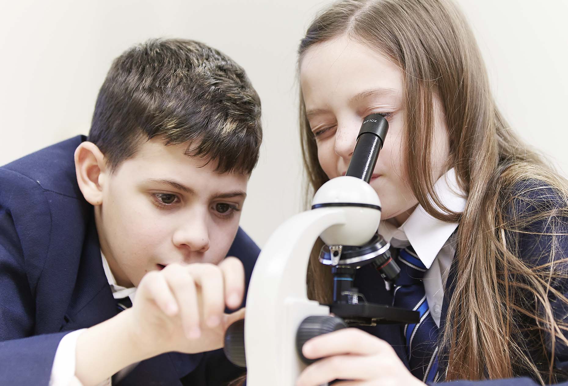 students learning using microscope